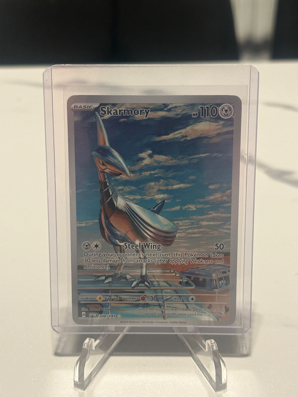 Skarmory - Holo Illustration Rare SV08: Surging Sparks 209/191 NM